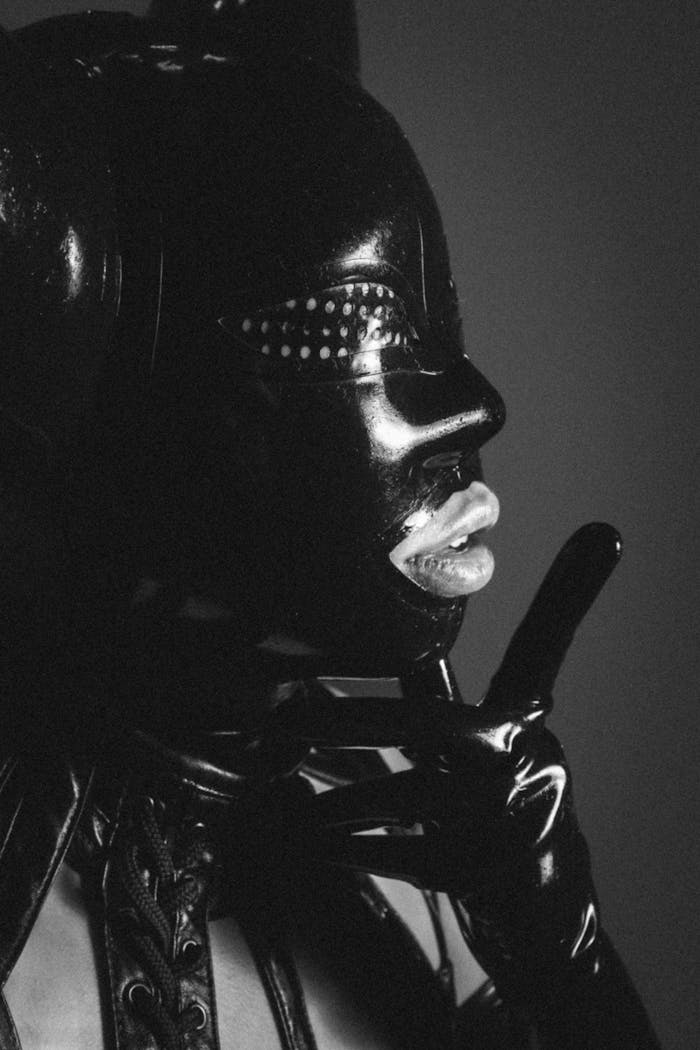 services-02 Dramatic black and white portrait of a person in a leather mask, showcasing surreal style.